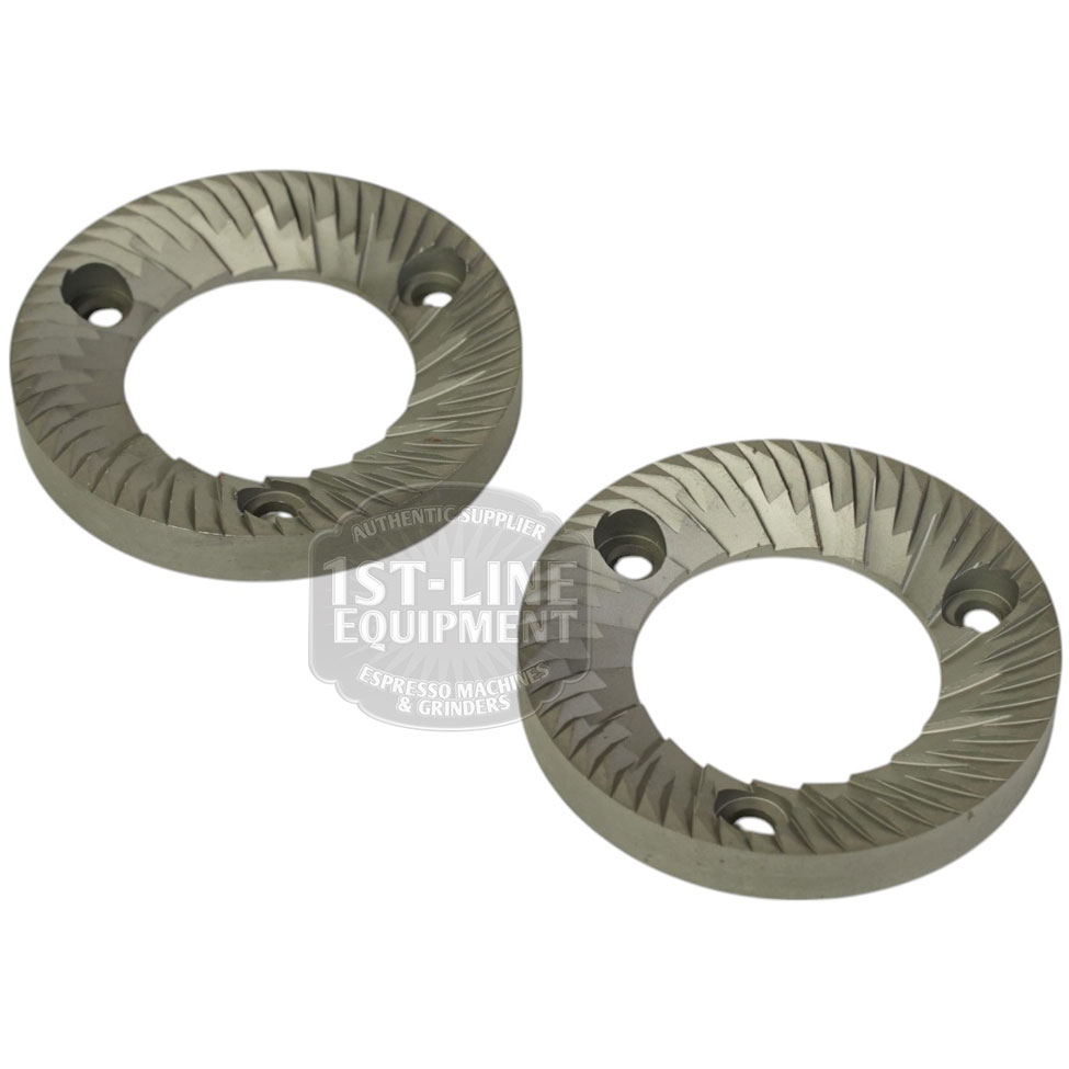 A set of two Mazzer FMA00182D/QQQ 1-phase 58mm flat grinding burrs, each with angled teeth and three screw holes, is shown on a white background. © 2025 1st-line.com