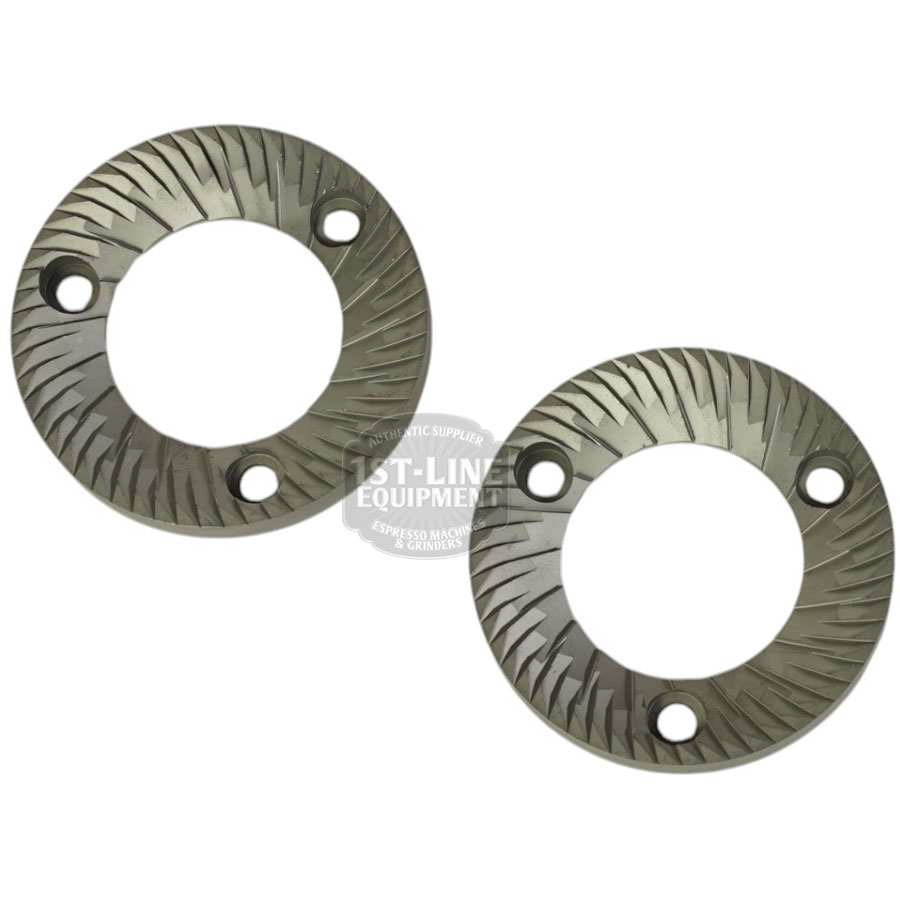 A set of two Mazzer FMA00182D/QQQ 1-phase 58mm Flat Grinding Burrs, each with four diagonal holes and angled ridges for precise grinding, displayed on a white background. © 2025 1st-line.com