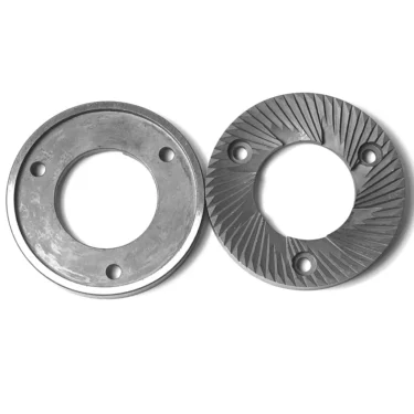 K..247 GRINDING BURRS: a set of two round metal burrs, each with a central hole and three screw holes—one smooth, one ridged/angled for grinding—likely used as coffee grinder burrs. © 2025 1st-line.com