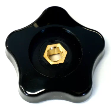 A black, five-pointed ECM P5999 Rotational Steam/Hot Water Knob with a gold hexagonal metal center insert, seen from above on a white background. © 2025 1st-line.com